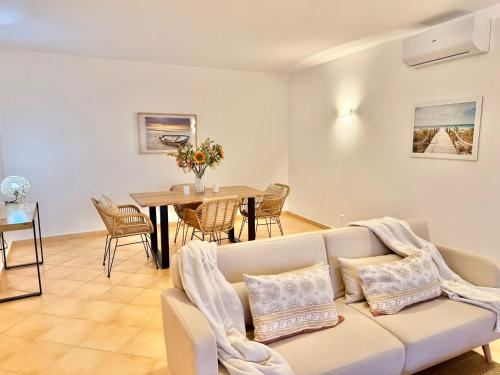 a living room with a couch and a table at Terrace View - Estrela Apartment in Luz