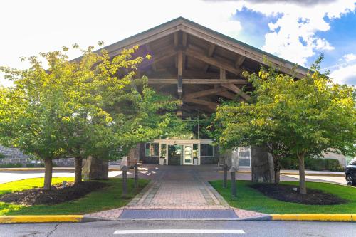 a building with trees in front of it at Sleepy Hollow Hotel, a Dolce by Wyndham in Tarrytown
