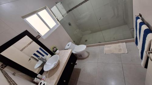 a bathroom with a shower and a toilet and a sink at Villa Casa blanca Con Alberca privada in Acapulco