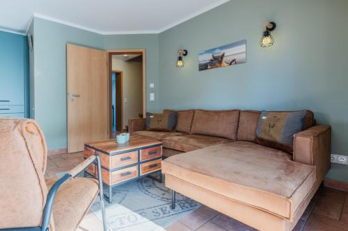 a living room with a couch and a table at Witter Barg - Ferienwohnung mit Sauna in Koserow
