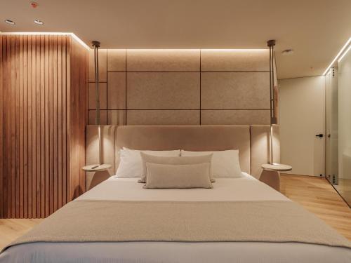 a bedroom with a large bed with a large headboard at Devú in Medellín