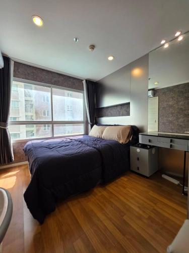 a bedroom with a bed and a desk and a sink at Modern Grey in Udon Thani