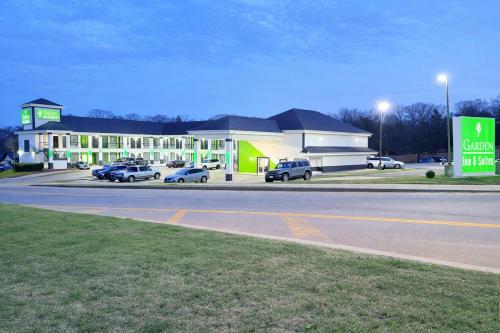 a gas station with cars parked in front of it at Garden Inn & Suites Little Rock in Little Rock