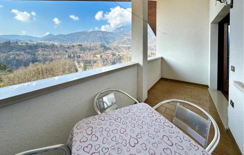 a balcony with a table and a view of the mountains at Awesome Apartment In Sovramonte With Wifi in Sovramonte