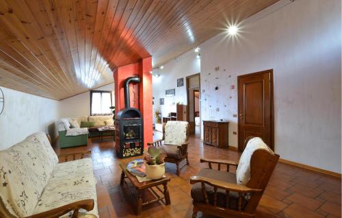 a living room with a couch and a fireplace at Awesome Apartment In Sovramonte With Wifi in Sovramonte