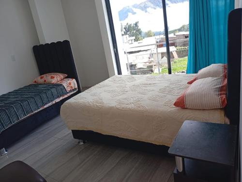 a bedroom with a bed and a large window at HOTEL CHOQOLAqA RESTAURANT in Cabanaconde