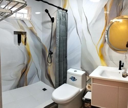 a bathroom with a shower and a toilet and a sink at PNAF Farm resort in Pililla