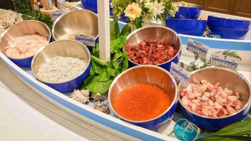 a counter with bowls of ingredients on a table at La Vista Atami Terrace in Atami