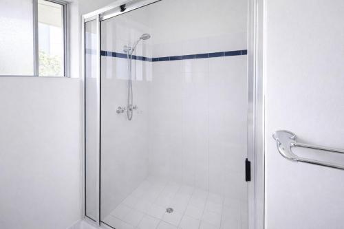 a shower with a glass door in a bathroom at Scarborough Beach Front Resort - Shell Thirteen in Perth