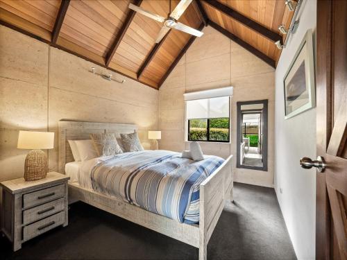 a bedroom with a bed and a window at Whalers Cove Villas in Dunsborough