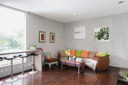 a living room with a couch and a table at Urbanview Hotel The Lodge Karawaci in Tangerang