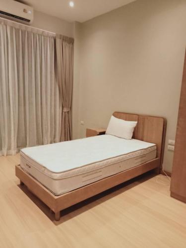 a bed sitting in a room with a window at Patra Phuket Private Residence in Ban Nong Chaeng