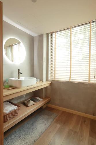 a bathroom with a sink and a mirror at 拾贰小院 in Zhongyantou