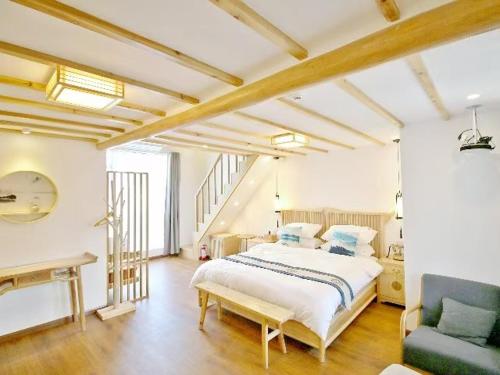 a large bedroom with a bed and a couch at 拾贰小院 in Zhongyantou