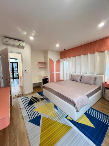 a bedroom with a large bed and a colorful rug at Biệt thự Hồ Tràm B SH42 in Xuyên Mộc