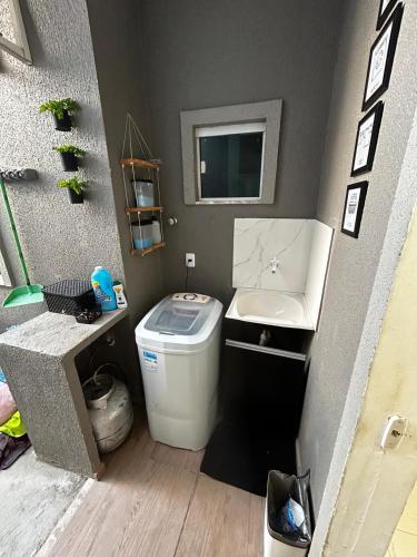 a small bathroom with a toilet and a sink at Casa Cristã Familiar JR in Paracuru