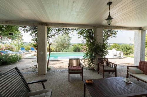 a patio with a table and chairs and a pool at La marquette in Montrabé