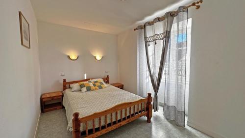 a bedroom with a bed and a large window at Le gîte communal in Dompierre-les-Églises