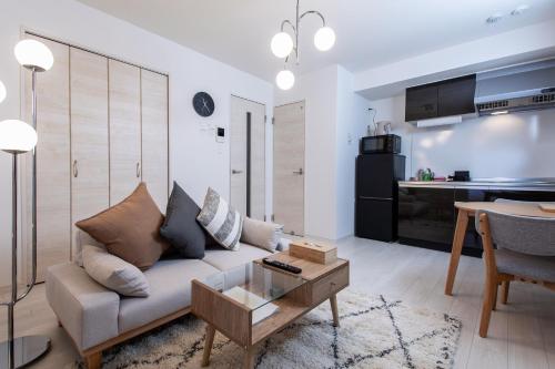 a living room with a couch and a table at New Open! SunLight 岸里 in Osaka