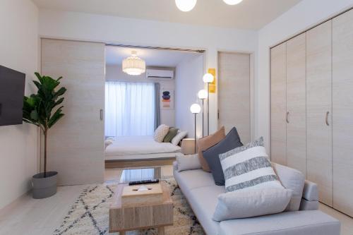 a living room with a couch and a table at New Open! SunLight 岸里 in Osaka