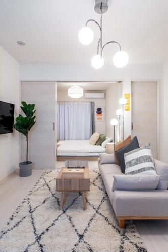 a living room with a couch and a table at New Open! SunLight 岸里 in Osaka