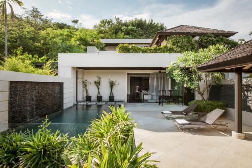 an external view of a house with a swimming pool at The Pavilions Phuket in Bang Tao Beach
