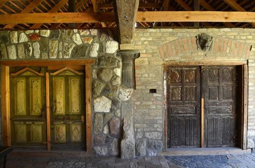 two doors on the side of a stone building at Zengőalja Vendégház in Erzsébet