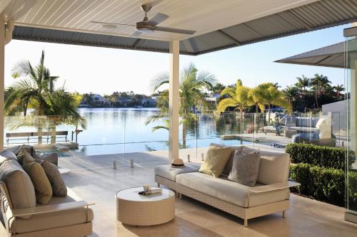 a living room with a view of the water at The Peninsula Secret - spacious waterfront & heated Spa in Noosaville