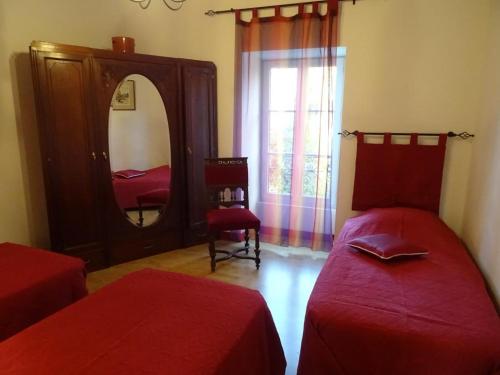 a bedroom with two beds and a large mirror at Les séquoias in Javerdat
