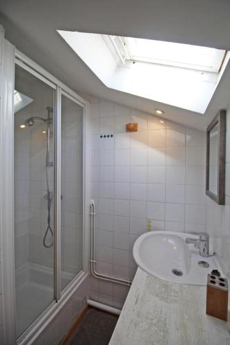 a bathroom with a tub and a shower and a sink at Lou peyrahout in Javerdat