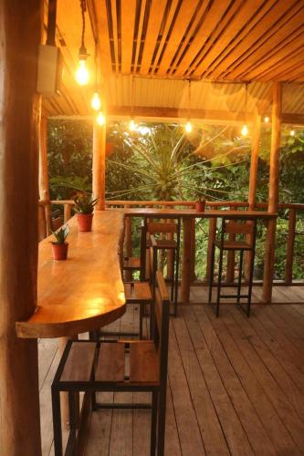 a wooden table and chairs on a wooden deck at Finca Kapok tree in Miramar