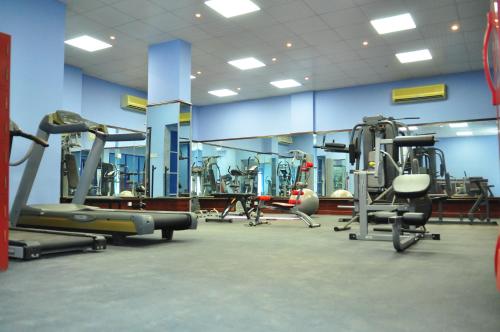 a gym with several tread machines in a room at Al Bahjah Hotel in Seeb