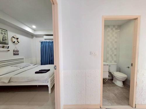 a white bedroom with a bed and a toilet at Pool Marine Hua-Hin Private Poolvilla from beach 4 km in Hua Hin