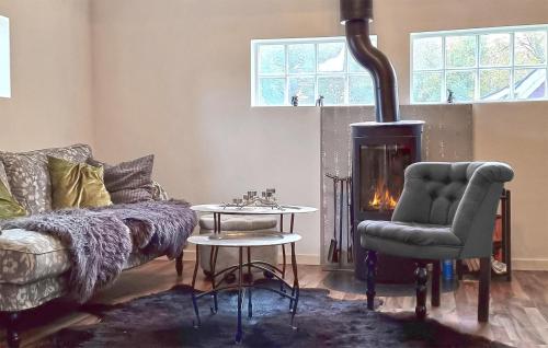 a living room with a couch and a fireplace at 2 Bedroom Nice Home In Örkeljunga in Orkelljunga