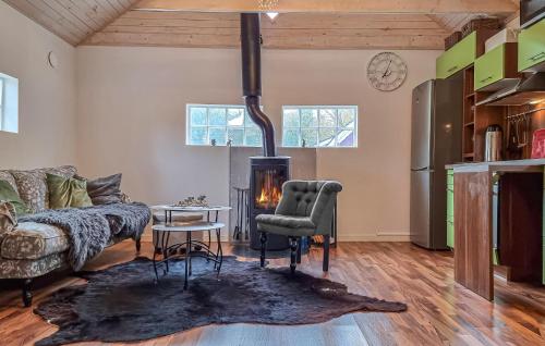 a living room with a couch and a fireplace at 2 Bedroom Nice Home In Örkeljunga in Orkelljunga