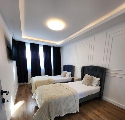 a room with two beds and a window at David’s place in Floreşti
