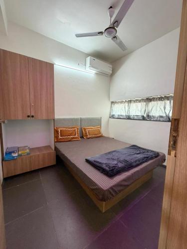 a bedroom with a large bed in a room at Kimaya Cottage - 2BHK 1 Washroom in Trimbak