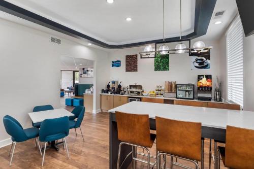 a kitchen and dining room with a table and chairs at Clarion Pointe Morrow - Atlanta South in Morrow
