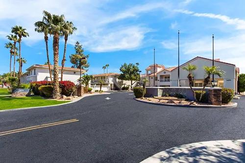 a street with a house and palm trees at Baymont Inn & Suites by Wyndham Tempe University/Phoenix in Tempe