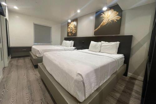 a hotel room with two beds and a window at Baymont Inn & Suites by Wyndham Tempe University/Phoenix in Tempe