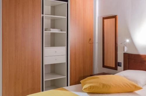 a bedroom with a mirror next to a bed at Residence Can' Hibiscus in Le Marin