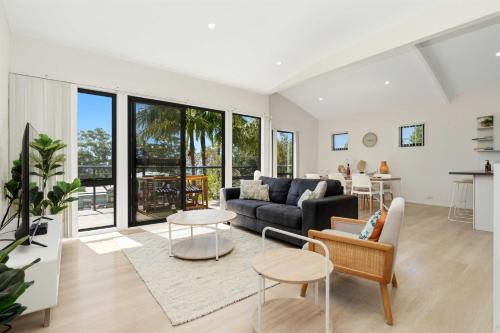 a living room with a couch and a table at Portside at The Arc by Experience Jervis Bay in Vincentia