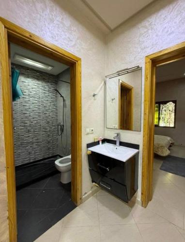 a bathroom with a sink and a toilet at Ferme agafay in El Karia