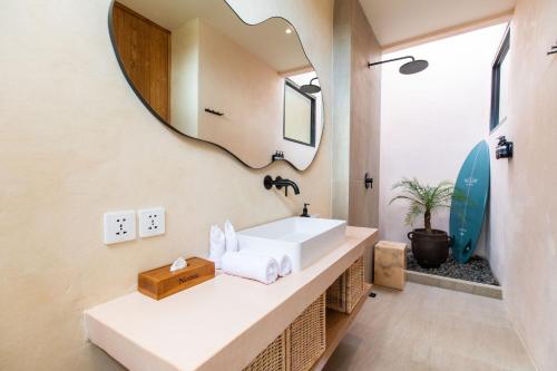 a bathroom with a sink and a mirror at Nema Uluwatu in Uluwatu
