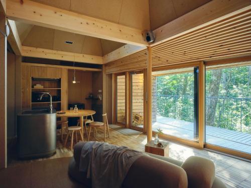 a kitchen and living room of a house with a table at SANU 2nd Home 白馬 1st in Hakuba
