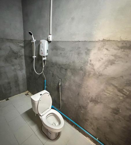 a bathroom with a white toilet in a room at Views Backpackers Hostel in Nongkhiaw