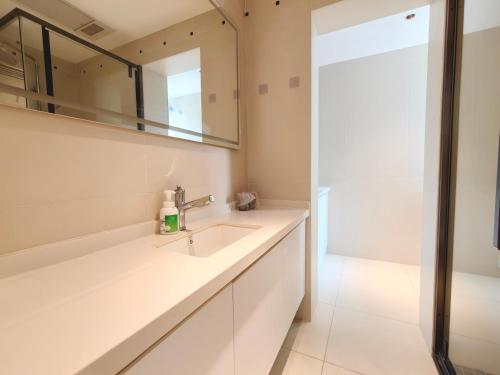 a bathroom with a sink and a mirror at Merit黄浦 Bright and Modern 2Bed Condo unit in downtown Shanghai in Shanghai