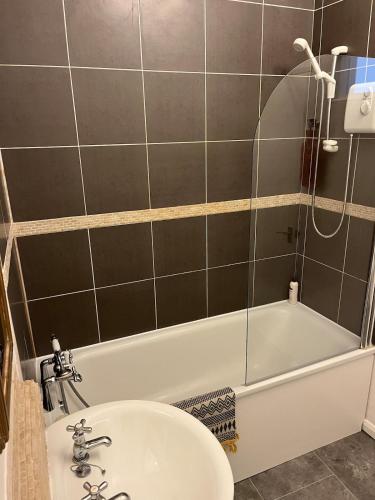 a bathroom with a tub and a sink and a shower at Large town flat 2 minutes from Pembroke Castle in Pembroke