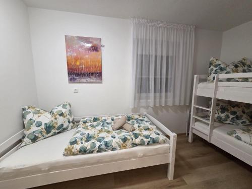 a bedroom with two beds and a bunk bed at Urlaub am Weinhof Ramminger in Gleisdorf
