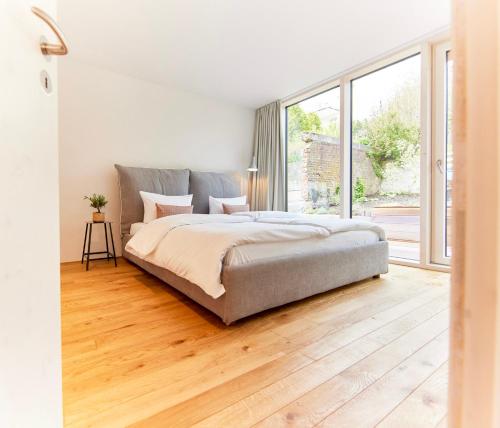 a bedroom with a bed and a large window at Netzschuppen in Kappeln